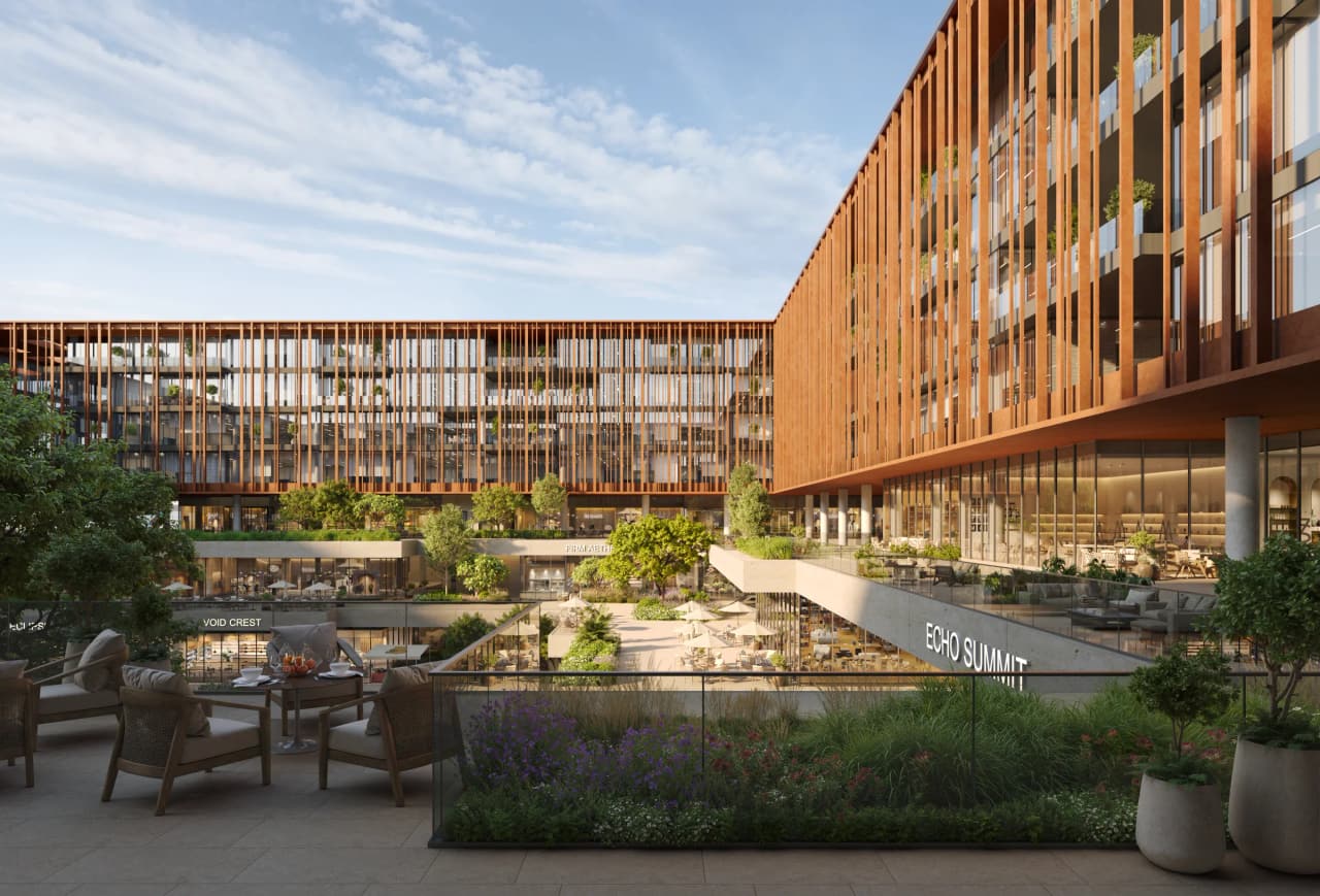 Central courtyard of The Yards Plaza with shaded seating, lush planting and café terraces between the four office blocks