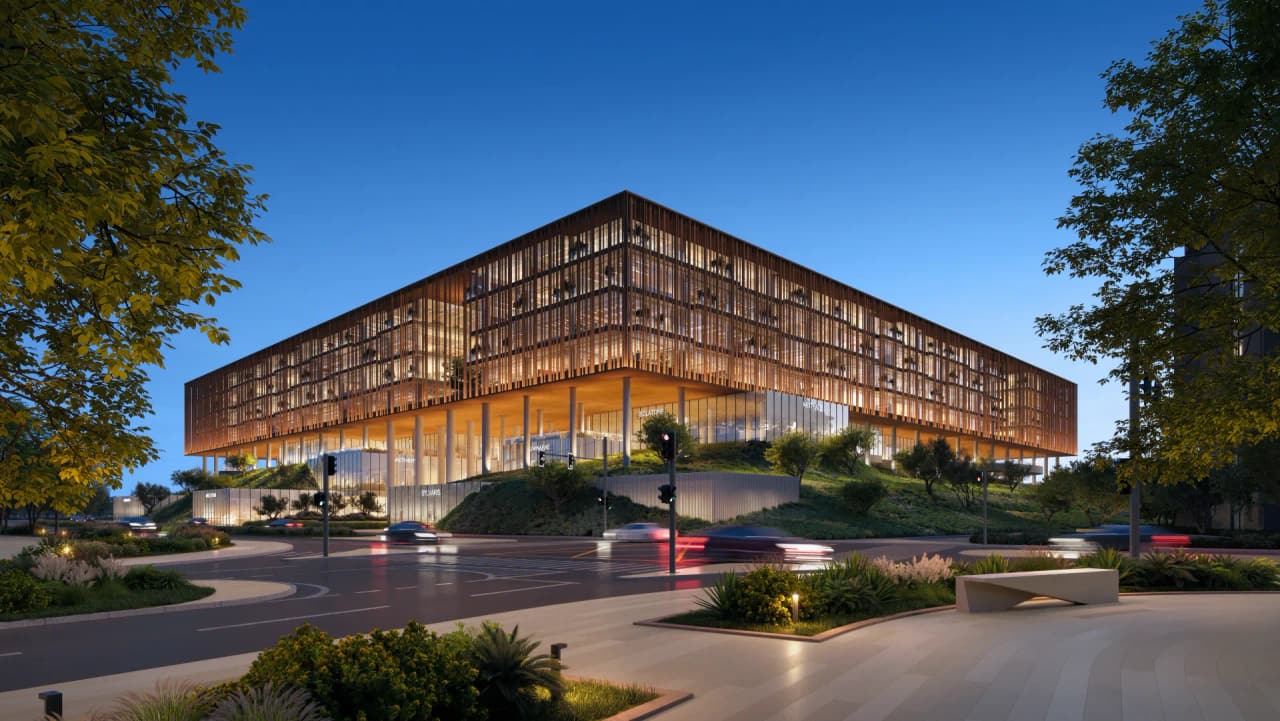 The Yards Plaza at dusk, with warm light behind the copper fins of the office blocks